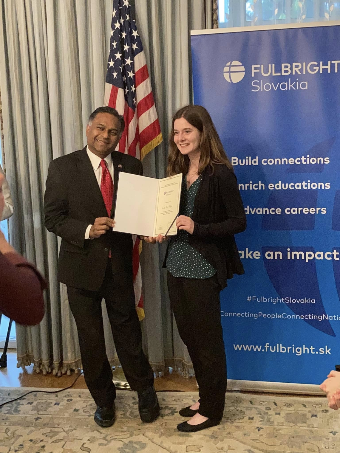 ETA posing for a photo in front of the Fulbright Slovakia banner