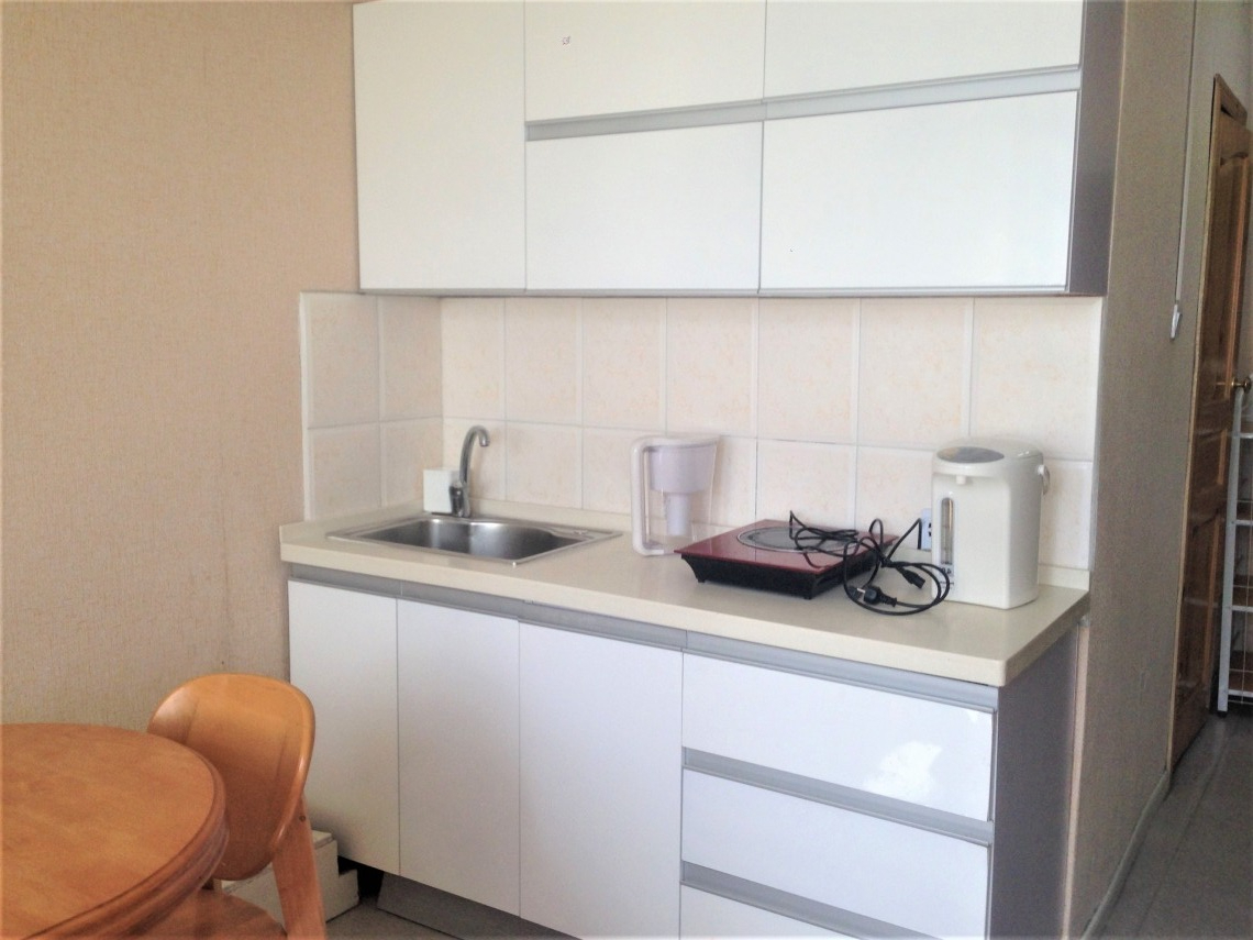 Kitchen with counter, sink, and table